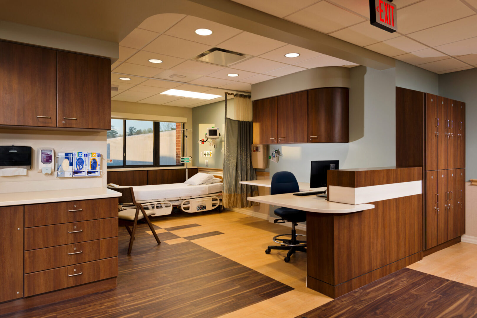 A hospital room with wooden floors and furniture.